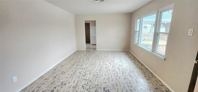 unfurnished room with light hardwood / wood-style floors