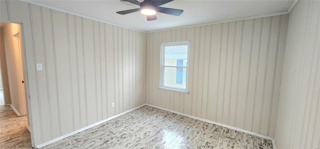 spare room with ornamental molding and ceiling fan