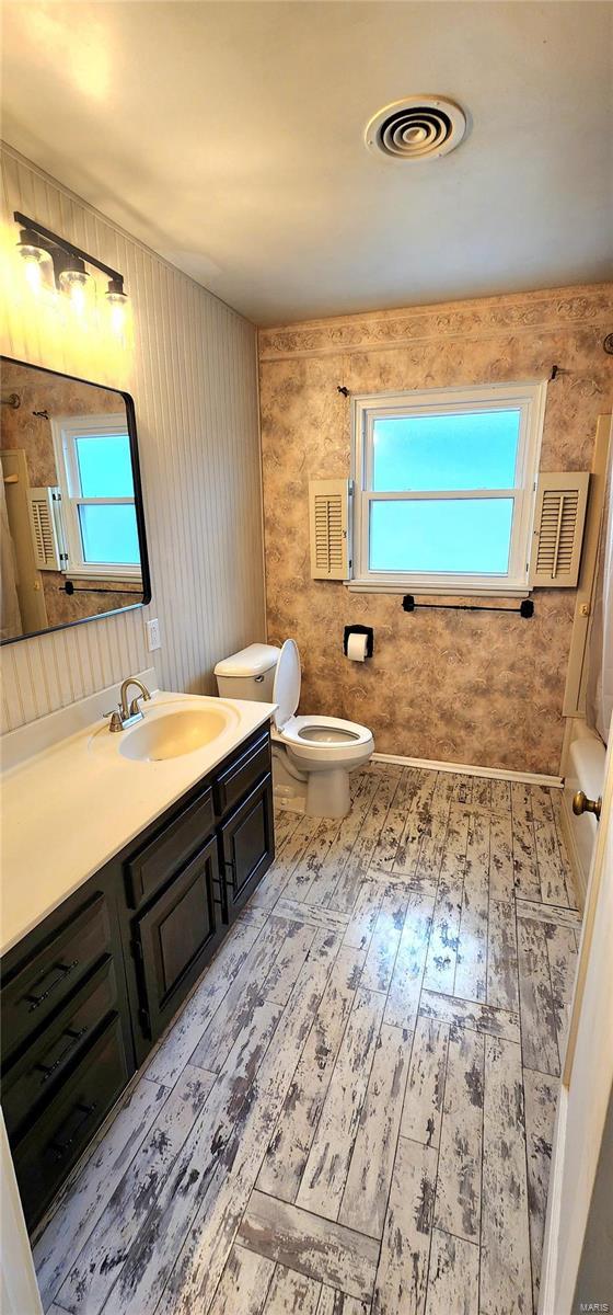 bathroom featuring hardwood / wood-style floors, toilet, and vanity