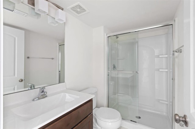 bathroom with vanity, toilet, and walk in shower