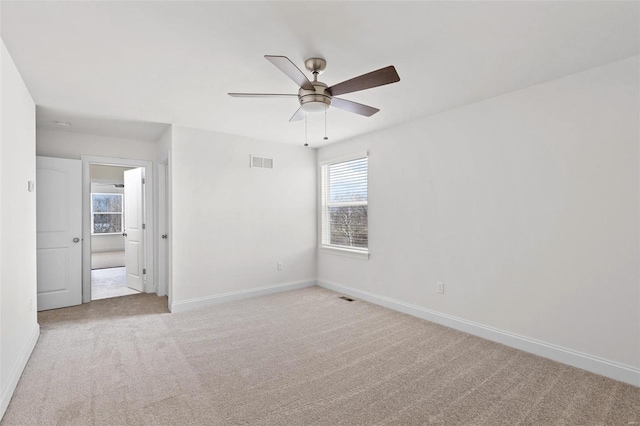 unfurnished bedroom with light colored carpet and ceiling fan