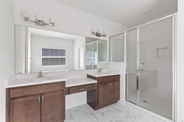 bathroom with vanity and a shower with door