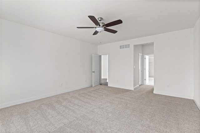 empty room with ceiling fan and light colored carpet