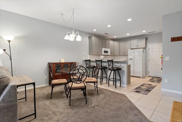 dining space with light tile patterned floors, baseboards, a chandelier, and recessed lighting