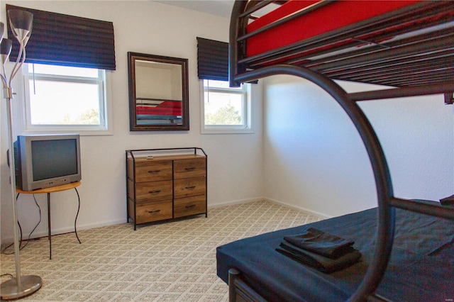 bedroom with carpet flooring and baseboards