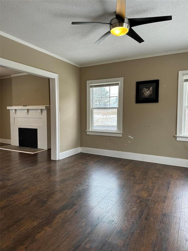 unfurnished living room with ceiling fan, crown molding, dark hardwood / wood-style flooring, and a fireplace