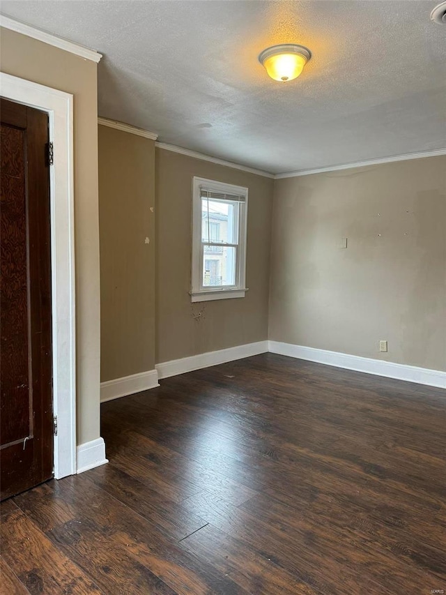 unfurnished room featuring a textured ceiling, dark wood-type flooring, and ornamental molding