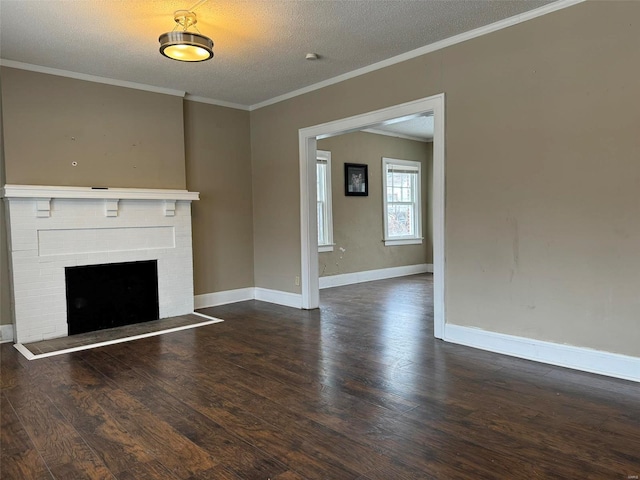 unfurnished living room featuring baseboards, ornamental molding, a textured ceiling, and wood finished floors
