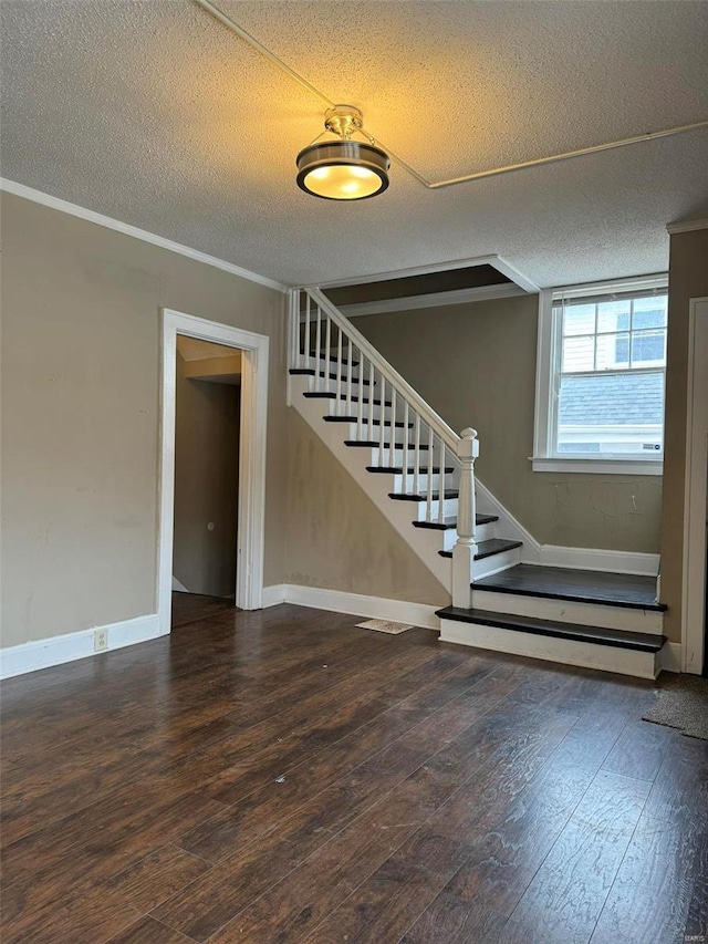 interior space featuring crown molding, a textured ceiling, and hardwood / wood-style floors