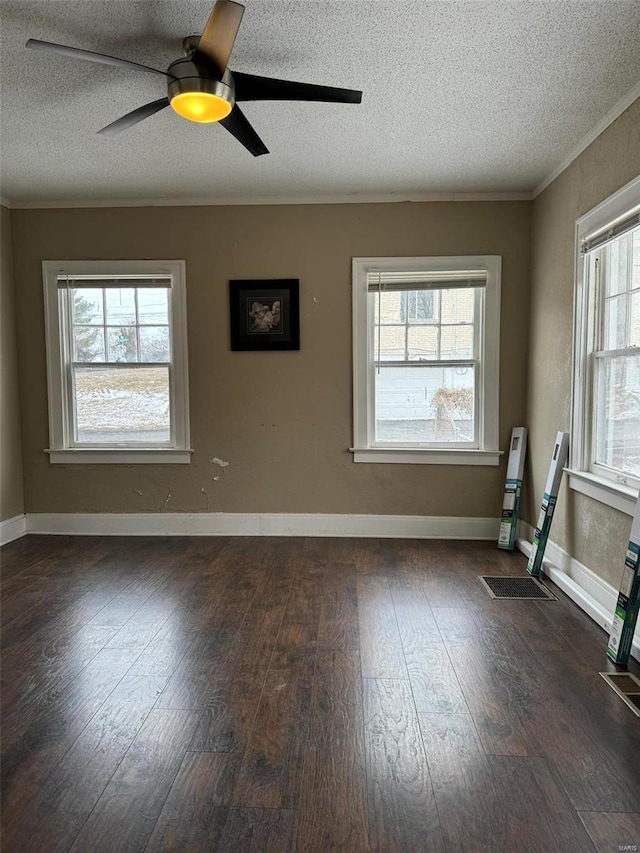 empty room featuring a ceiling fan, a textured ceiling, and wood finished floors