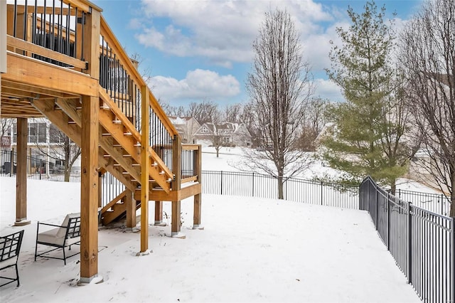 snowy yard with a fenced backyard