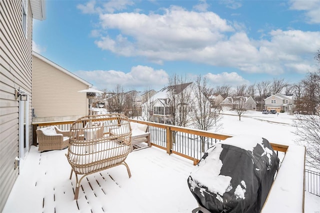 snow covered deck featuring a residential view and grilling area