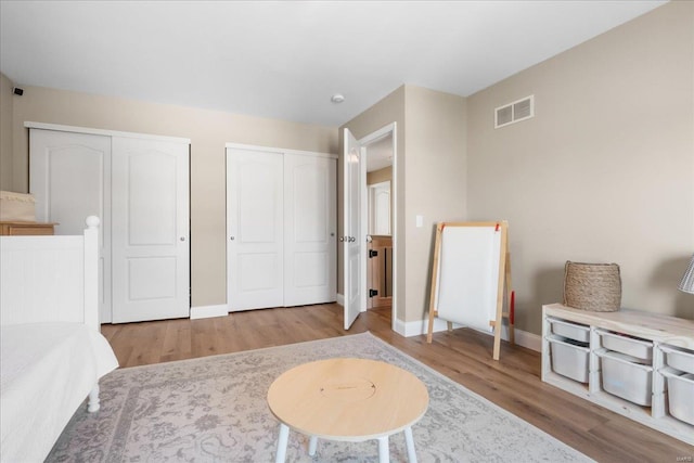 interior space featuring visible vents, light wood-style flooring, and baseboards