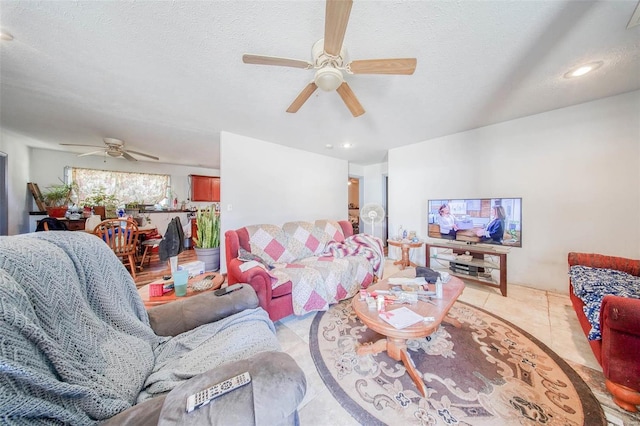 living room with a ceiling fan, recessed lighting, a textured ceiling, and light tile patterned floors