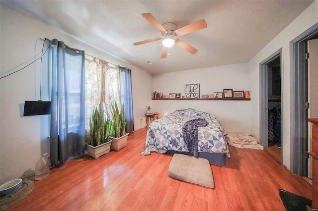 bedroom with ceiling fan and wood finished floors