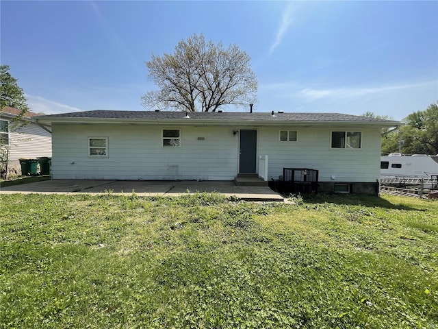 rear view of property featuring a yard