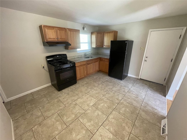 kitchen with light tile patterned flooring, under cabinet range hood, baseboards, black appliances, and brown cabinetry