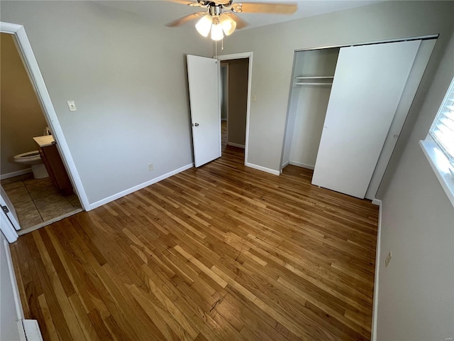 unfurnished bedroom with a ceiling fan, a closet, baseboards, and wood finished floors