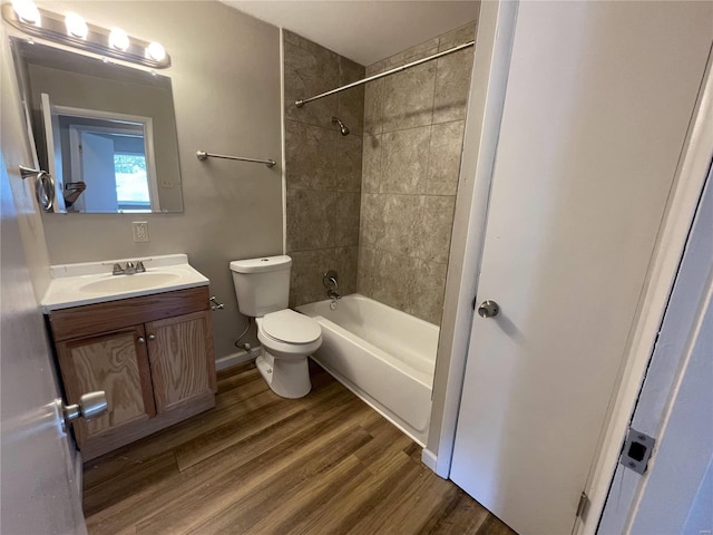 full bath featuring shower / tub combination, toilet, wood finished floors, vanity, and baseboards