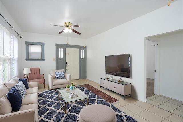 living room with ceiling fan and light tile patterned floors