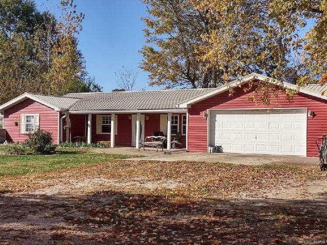 ranch-style home with a porch and a garage