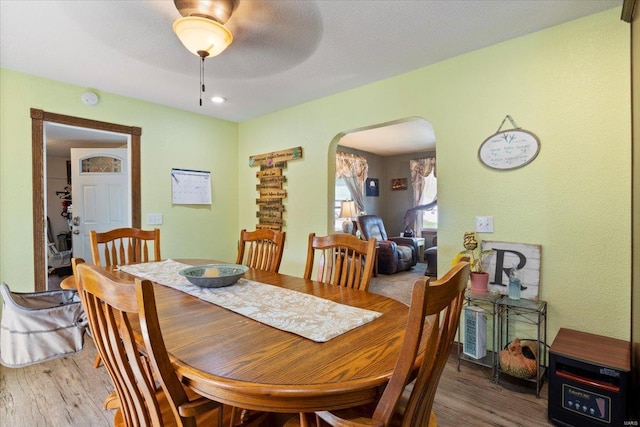 dining room with a textured ceiling and hardwood / wood-style floors