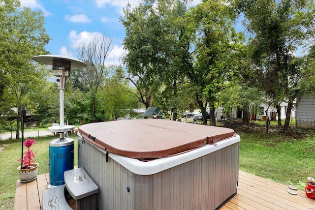 wooden terrace with a yard and a hot tub