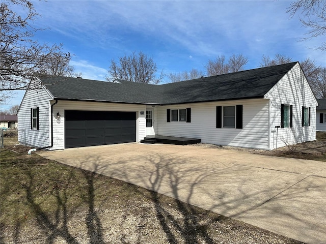 single story home featuring a garage, concrete driveway, and roof with shingles