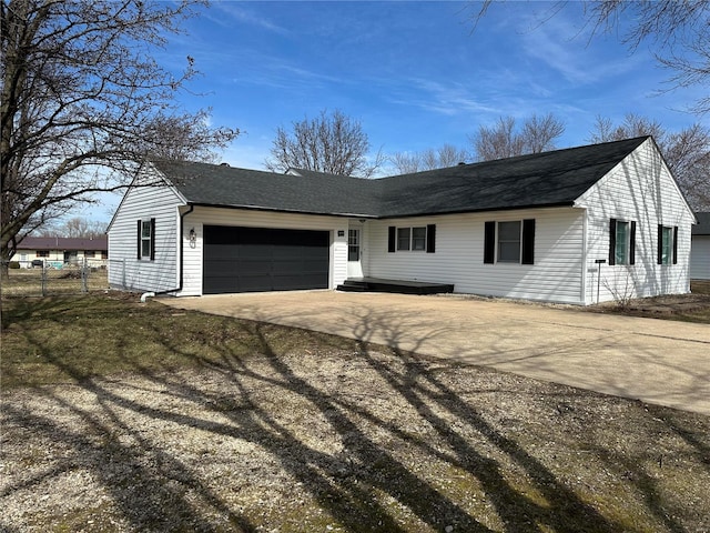 ranch-style home with driveway, a garage, fence, and roof with shingles