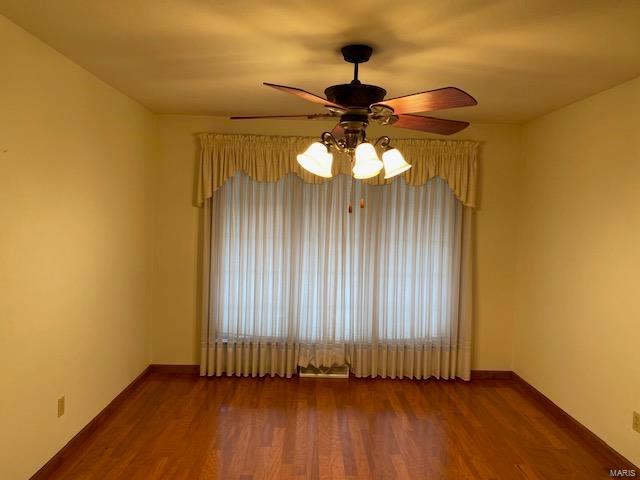 empty room with dark wood-type flooring