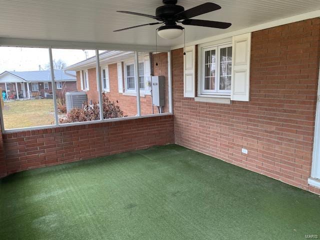 unfurnished sunroom with ceiling fan