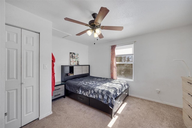 bedroom with attic access, baseboards, light colored carpet, ceiling fan, and a closet