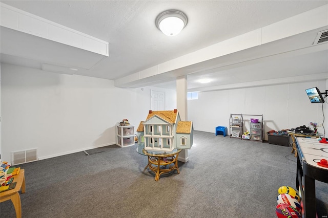 recreation room featuring carpet floors and a textured ceiling