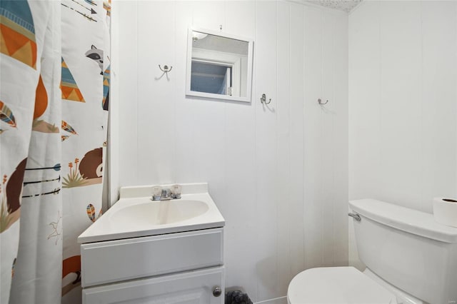 bathroom featuring toilet and vanity