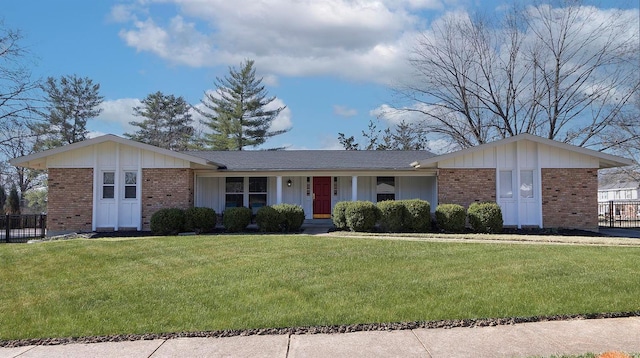 ranch-style home featuring brick siding, covered porch, and a front lawn