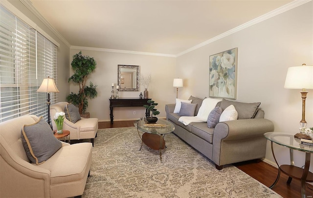 living area with crown molding, wood finished floors, and baseboards