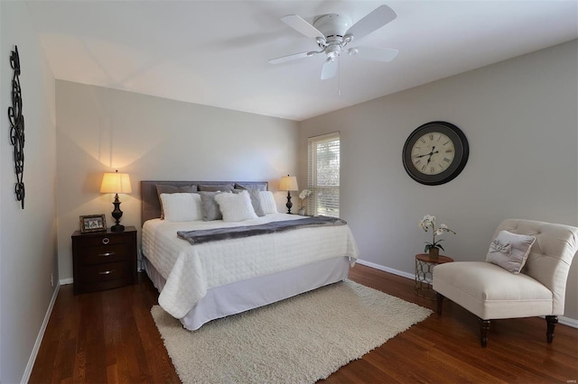 bedroom with dark wood finished floors, a ceiling fan, and baseboards