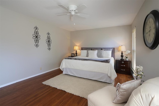 bedroom with ceiling fan, baseboards, and wood finished floors