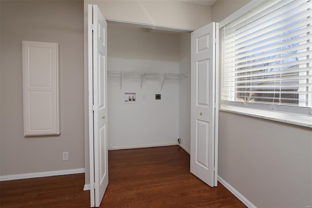 laundry room featuring washer hookup, laundry area, wood finished floors, and baseboards