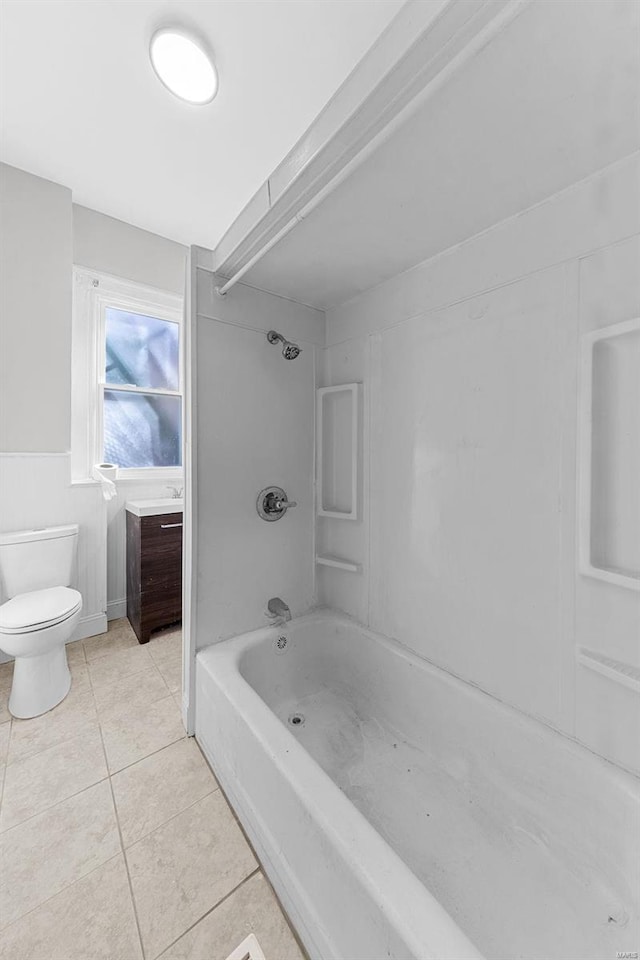 bathroom with toilet, tile patterned floors, tub / shower combination, and vanity