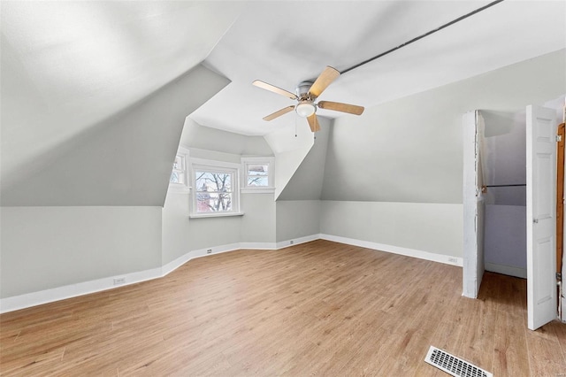 bonus room with visible vents, baseboards, vaulted ceiling, a ceiling fan, and light wood-type flooring
