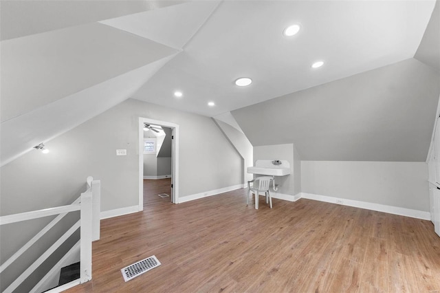 bonus room featuring lofted ceiling, recessed lighting, visible vents, wood finished floors, and baseboards