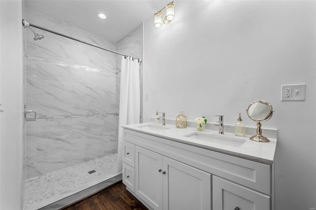 bathroom featuring hardwood / wood-style flooring, vanity, and curtained shower