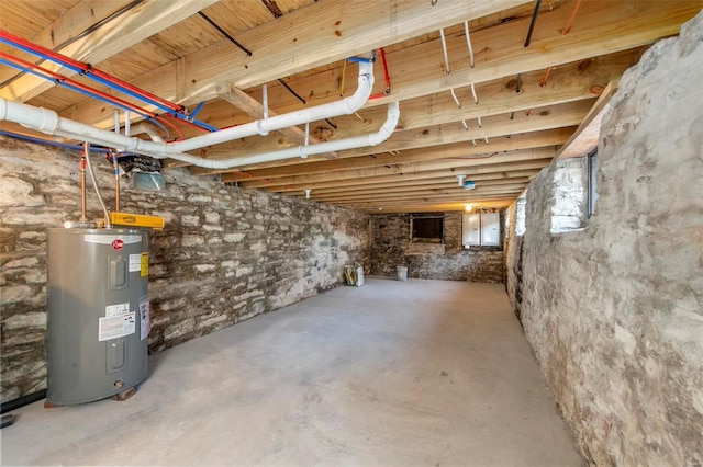 basement featuring water heater and electric panel