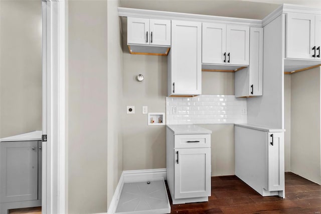 laundry room featuring washer hookup, dark hardwood / wood-style floors, cabinets, and electric dryer hookup