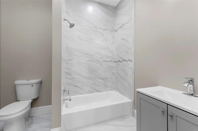 full bathroom with vanity, tiled shower / bath, and toilet