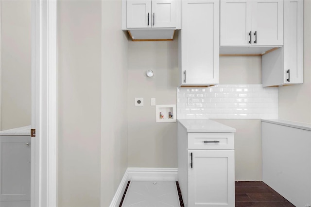 washroom featuring cabinets, hookup for an electric dryer, dark hardwood / wood-style flooring, and hookup for a washing machine