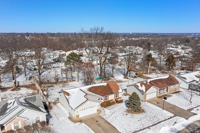 snowy aerial view with a residential view