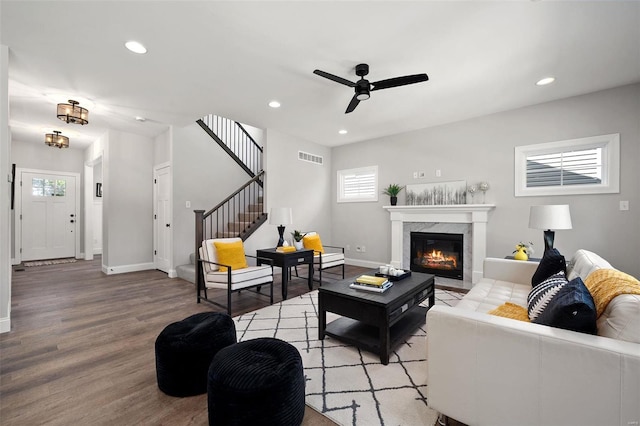 living room with stairs, light wood-style flooring, and recessed lighting