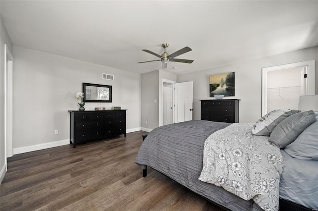 bedroom with a ceiling fan, visible vents, baseboards, and wood finished floors